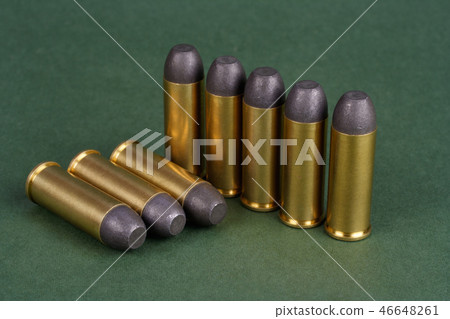 Western-style revolver cartridges on green  46648261
