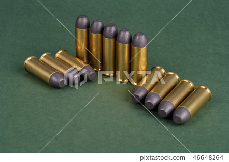 Western-style revolver cartridges on green Western-style revolver cartridges on green 46648264