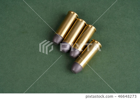 Western-style revolver cartridges on green  46648273