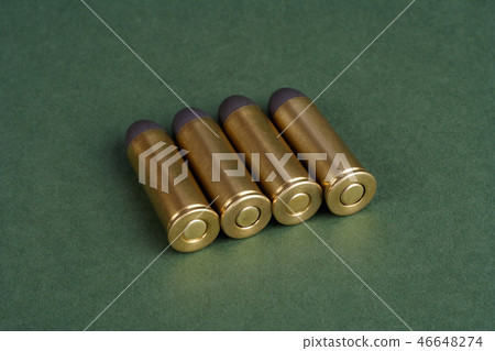 Western-style revolver cartridges on green  46648274