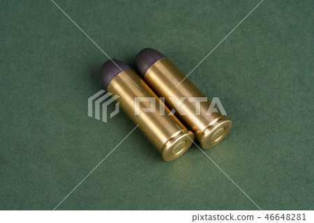 Western-style revolver cartridges on green Western-style revolver cartridges on green 46648281