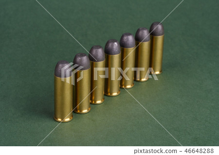 Western-style revolver cartridges on green  46648288