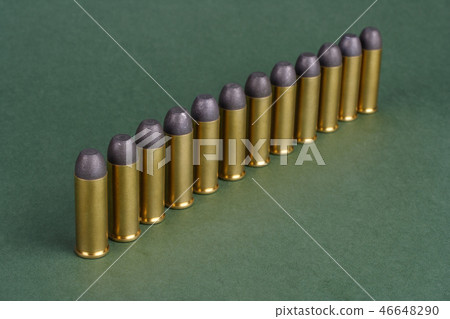 Western-style revolver cartridges on green  46648290