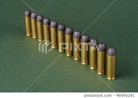 Western-style revolver cartridges on green  46648291