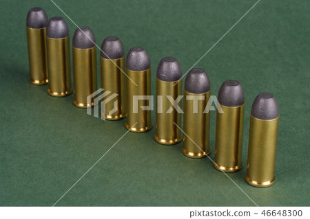 Western-style revolver cartridges on green  46648300