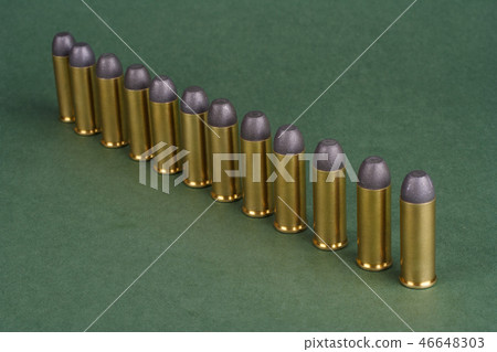 Western-style revolver cartridges on green  46648303