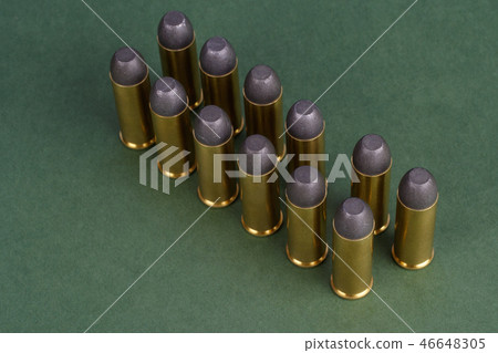 Western-style revolver cartridges on green  46648305