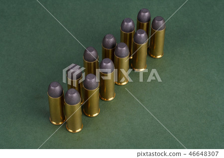 Western-style revolver cartridges on green  46648307