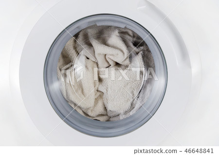 white clothes wash, closed washing machine with towel closeup white clothes wash, closed washing machine with towel closeup 46648841