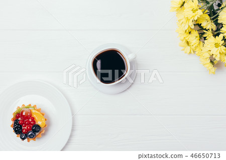 Flat lay cup of coffee on white wooden table Flat lay cup of coffee on white wooden table 46650713