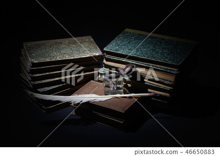 old books, papers, ink pen and inkpot on black  46650883