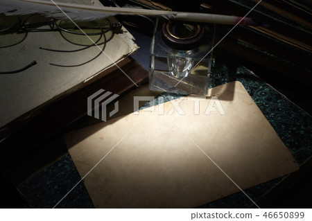 old books, papers, ink pen and inkpot on black  46650899