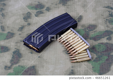 Ammunition with magazine on camoflage background 46651261