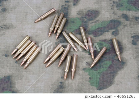 Ammunition on camoflage background Ammunition on camoflage background 46651263