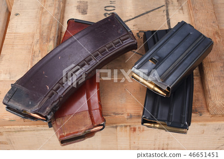 m16 and ak47 magazins on wooden box 46651451