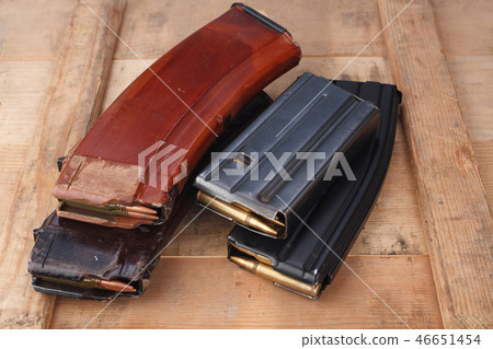 m16 and ak47 magazins on wooden box 46651454