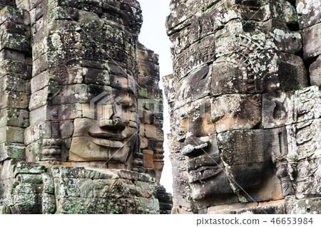 smiling stone face on tower at Bayon castle smiling stone face on tower at Bayon castle 46653984