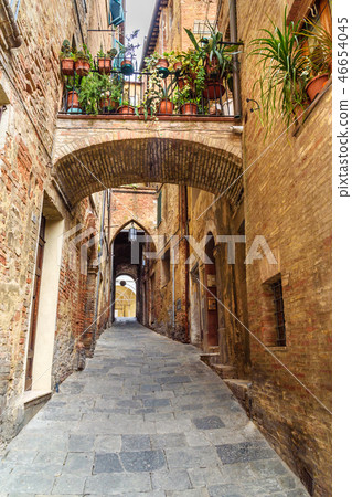 Medieval narrow street Vicolo Delle Scotte Siena 46654045