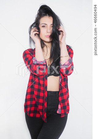 Playful young brunette posing in a plaid shirt. Playful young brunette posing in a plaid shirt. 46660494
