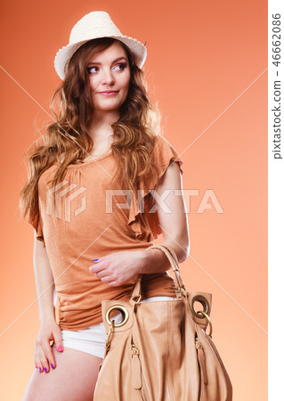 Lovely woman in summer hat handbag portrait 46662086