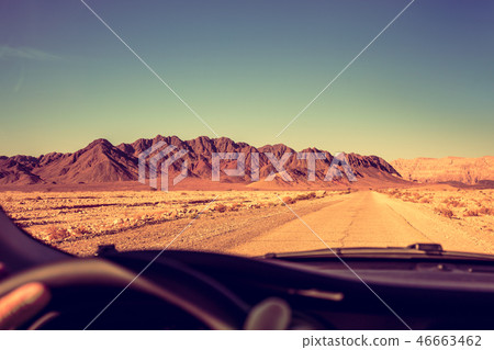 Driving a car on the road in the desert Driving a car on the road in the desert 46663462