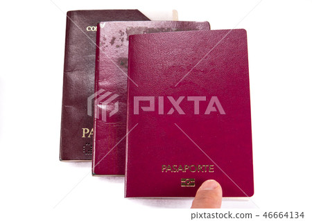 Finger pointint new blank passport over old expired ones Finger pointint new blank passport over old expired ones 46664134