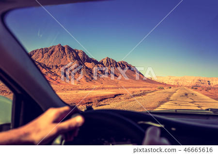 Driving a car on the road in the desert 46665616