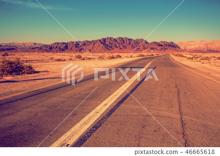 Road in a desert among mountains Road in a desert among mountains 46665618