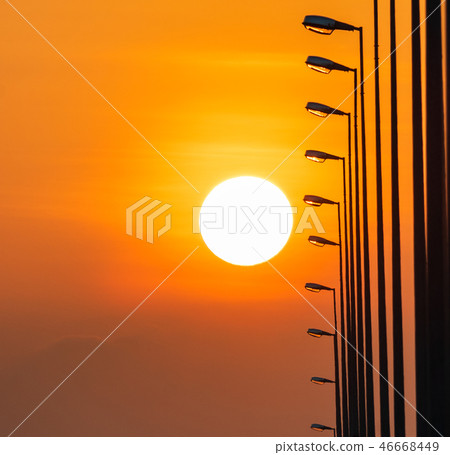 Street lamp poles and beautiful sunset sky. Street lamp poles and beautiful sunset sky. 46668449