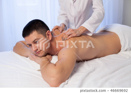 a massage therapist makes therapeutic massage Spa 46669692