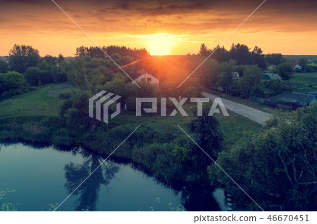 View of countryside and lake in evening View of countryside and lake in evening 46670451