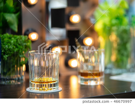 Two almost empty glasses of whiskey Two almost empty glasses of whiskey 46670997