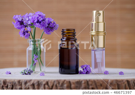 lavender water and essential oil bottle and fresh lavender flowers for relax on brown background 46671397