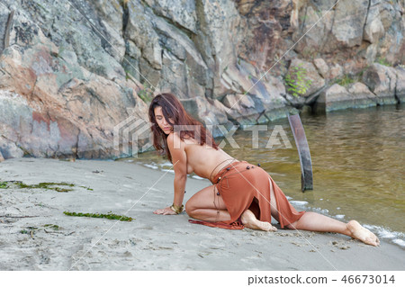 young beautiful naked woman on sand river beach 46673014