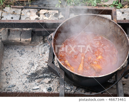big heavy cauldron with vegetable meat stew 46673461