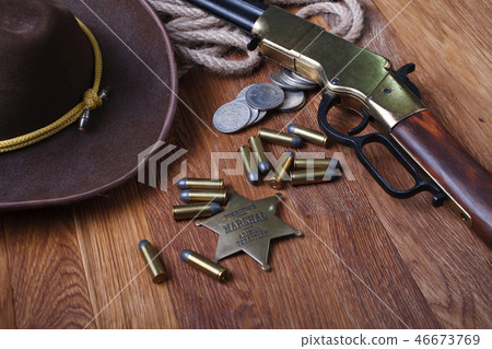 Wild west rifle, ammunition and sheriff badge Wild west rifle, ammunition and sheriff badge 46673769