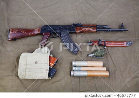 Kalashnikov AK 47 on canvas background Kalashnikov AK 47 on canvas background 46673777