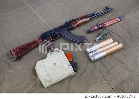 Kalashnikov AK 47 on canvas background Kalashnikov AK 47 on canvas background 46673778