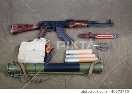 Kalashnikov AK 47 on canvas background Kalashnikov AK 47 on canvas background 46673779