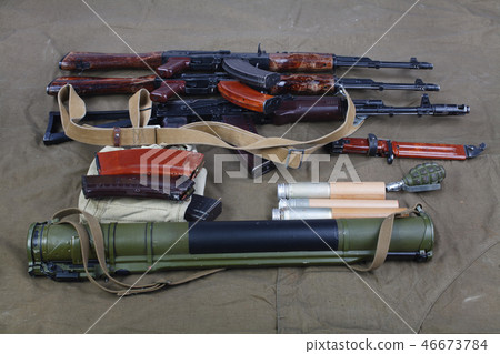 Kalashnikov AK 47 on canvas background Kalashnikov AK 47 on canvas background 46673784