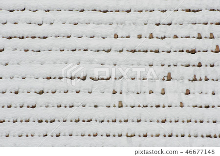 The roof of clay tiles covered with snow. Texture The roof of clay tiles covered with snow. Texture 46677148