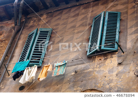 Windows with wooden shutters of old house in Siena Windows with wooden shutters of old house in Siena 46678894