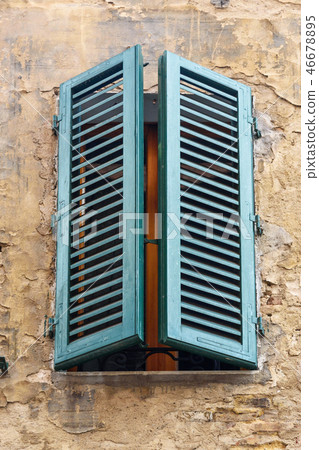 Window with wooden shutters of old house in Siena Window with wooden shutters of old house in Siena 46678895