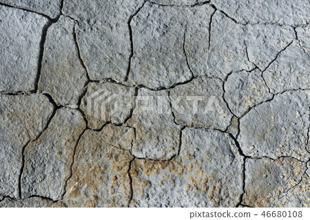 Gray light dry cracked surface of volcanic earth 46680108