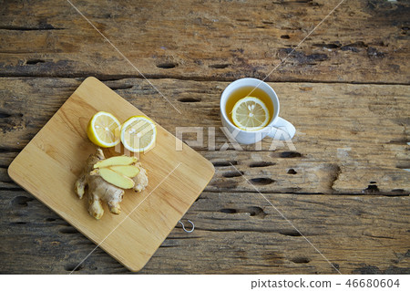 Cup of ginger tea with lemon on wooden 46680604