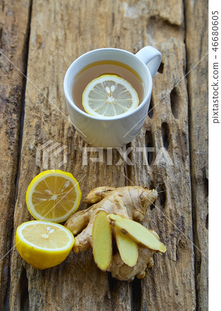 Cup of ginger tea with lemon on wooden 46680605