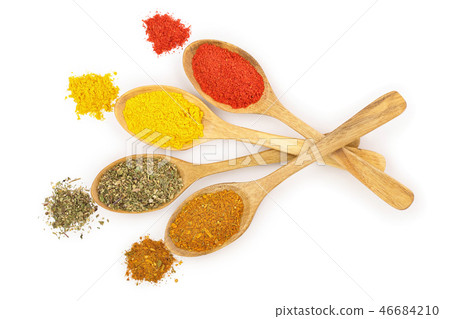 mix of spices in wooden spoon isolated on a white background. Top view. Flat lay. Set or collection 46684210