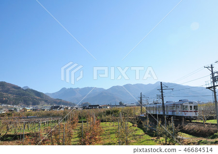 Nagano Electric Railway 3500 series trains that run through the orchards of the dead in the background of the mountains of Shiga Kogen 46684514