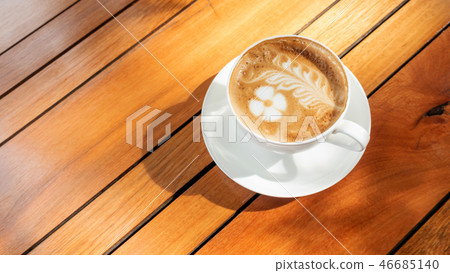 Hot latte coffee on a wooden table. 46685140