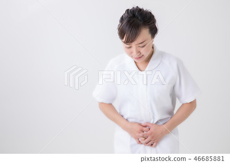 Woman in white coat holding a stomach 46685881